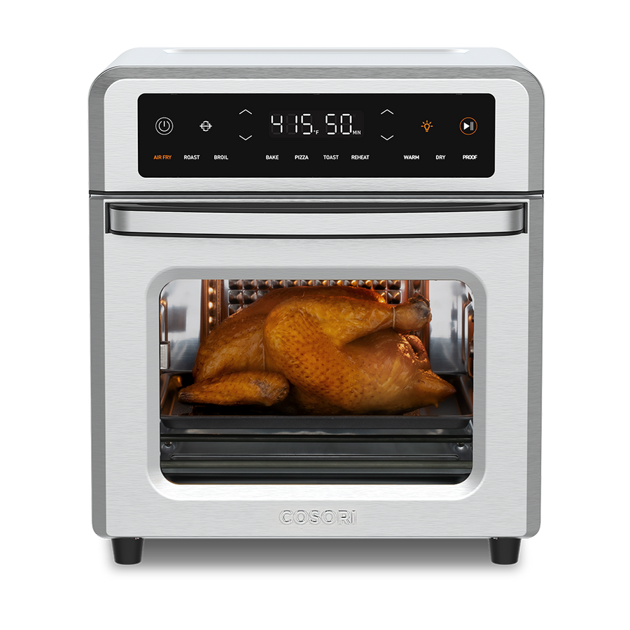 COSORI CAF-R121-SUS 13-quart countertop air-fryer oven viewed from the front with a chicken in the oven cavity